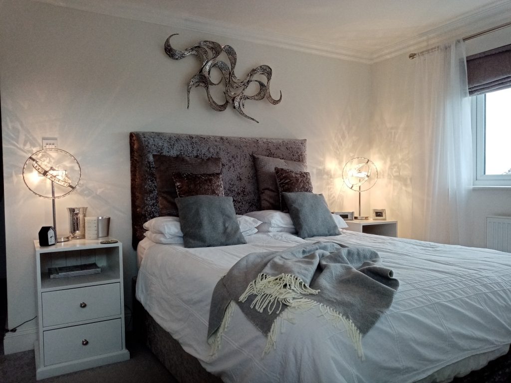 Bedroom designed by Paint and Plan in greys and whites - bed with rumpled blanket
